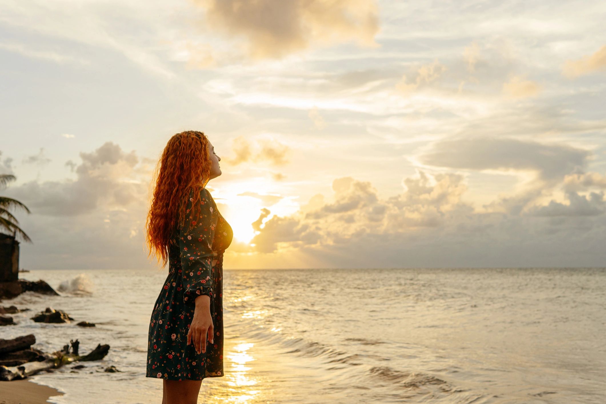 Woman enjoying the sunset at the beach.