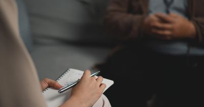 Person taking notes during a conversation.