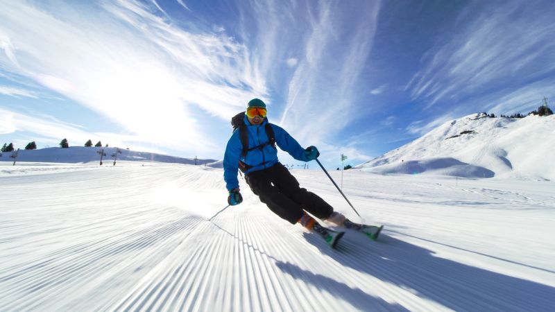 professional skier skiing on slopes in the Swiss alps towards the camera
