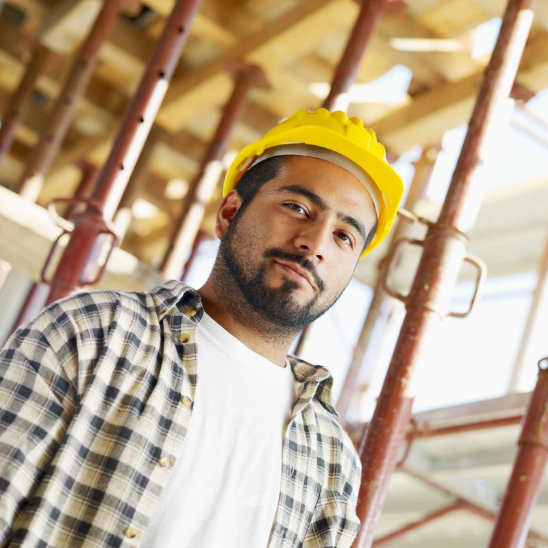 latin american construction worker looking at camera. 