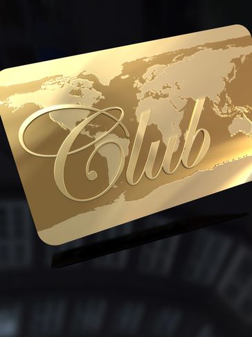 Close-up of a golden card with a world map and cursive lettering.