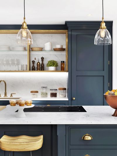Elegant modern kitchen with blue cabinets and marble countertop.
