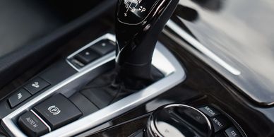Close-up of a car's automatic gear shifter and control buttons.