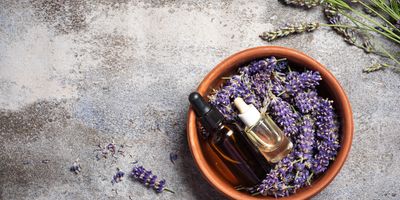 Essential oils and lavender in a bowl.