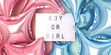Pink and blue balloons with a lightbox saying 'BOY OR GIRL'