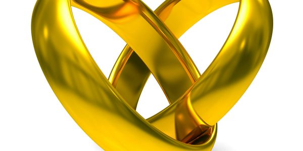 Two intertwined gold rings forming a heart shape.