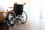 Empty wheelchair in a bright, sunlit room.