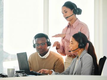 Three people working a customer support