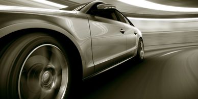 A sleek car speeding through a tunnel with motion blur effect.