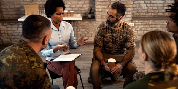 Counseling session with military personnel and a therapist.