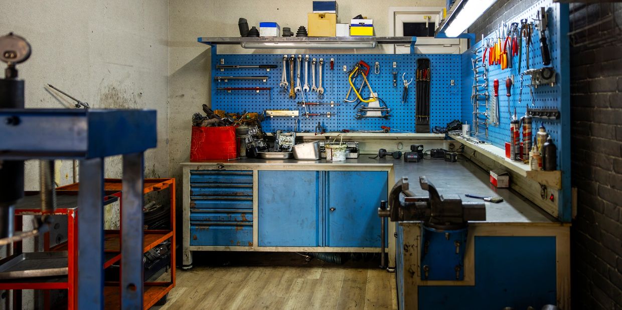 “Pro tools laid out on a workbench with drills, saws, speed square and gloves ready for any project.