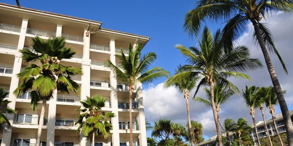 Timeshare resale resort on Maui, Oahu, Big Island, or Kauai, with palm trees.