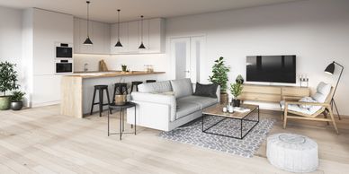 Cuisine moderne avec îlot central, armoires blanches et aire ouverte.