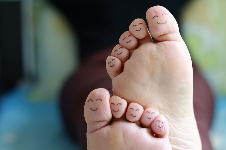 Happy faces drawn on all ten toes of a foot. Colchester foot care.
