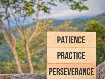 Wooden blocks with motivational words in nature.