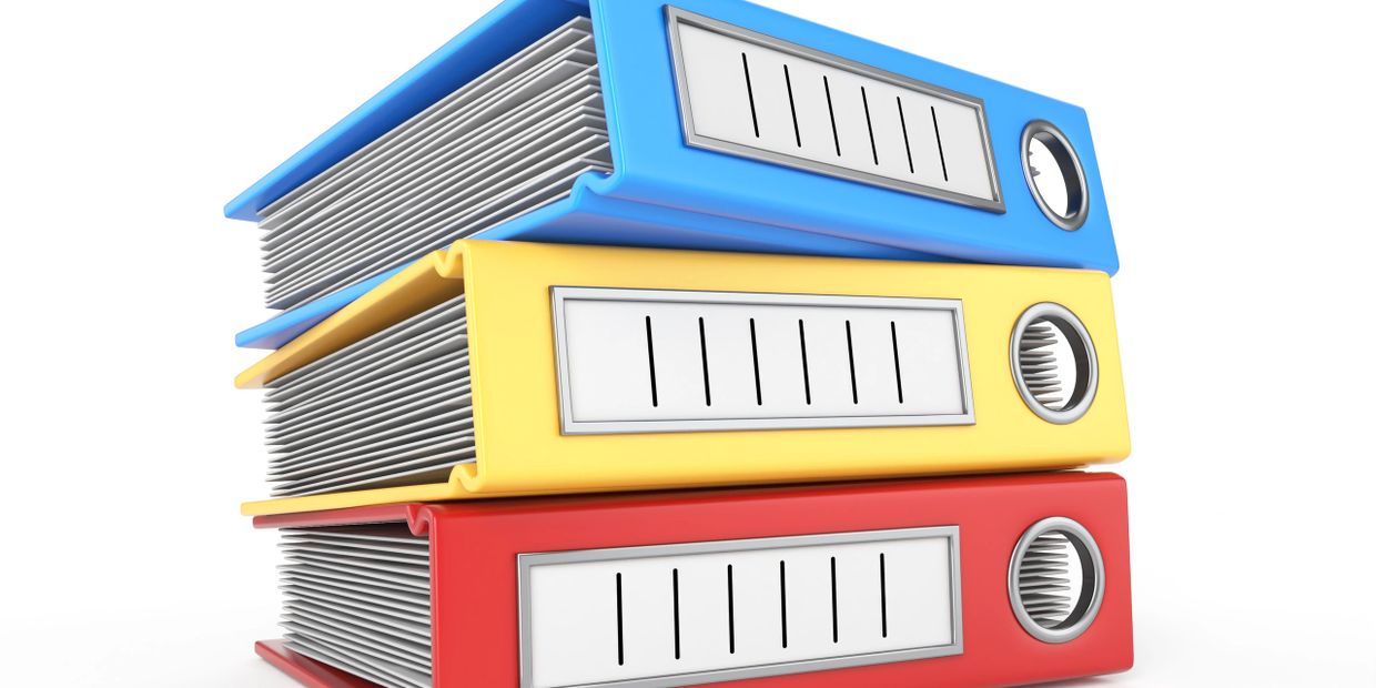Stack of colorful office binders filled with papers.