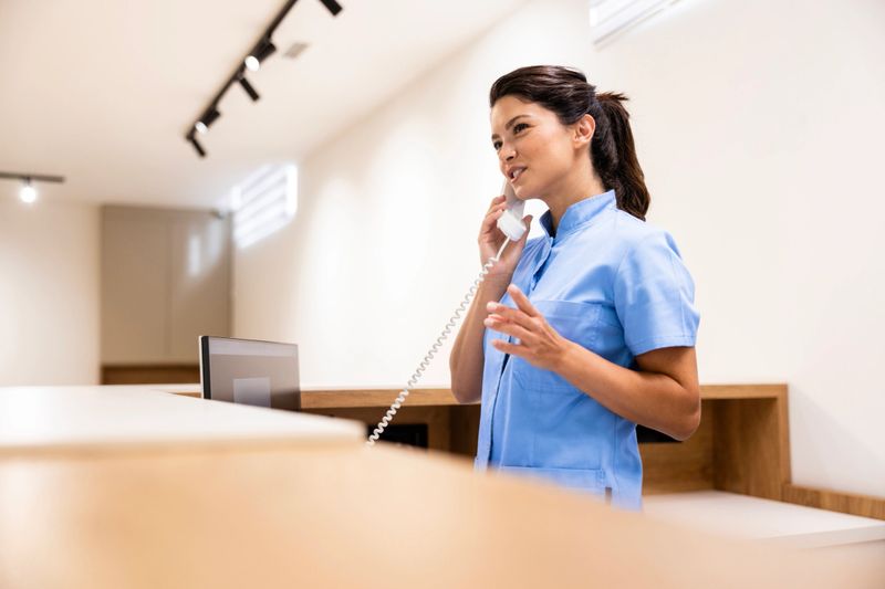 Hospital receptionist answering the call and making an appointment.