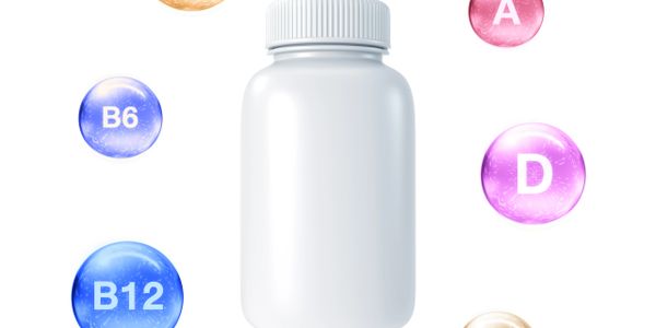 A white supplement bottle surrounded by colorful vitamin symbols.