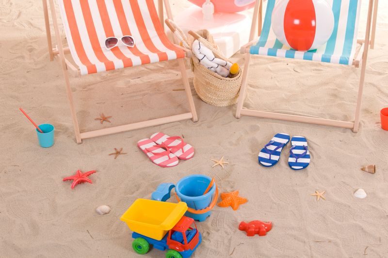 beach chair with colorful towel and toys