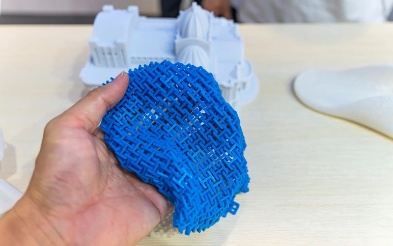 Person holding in hand model printed on a 3D printer from polyamide powder using new technology