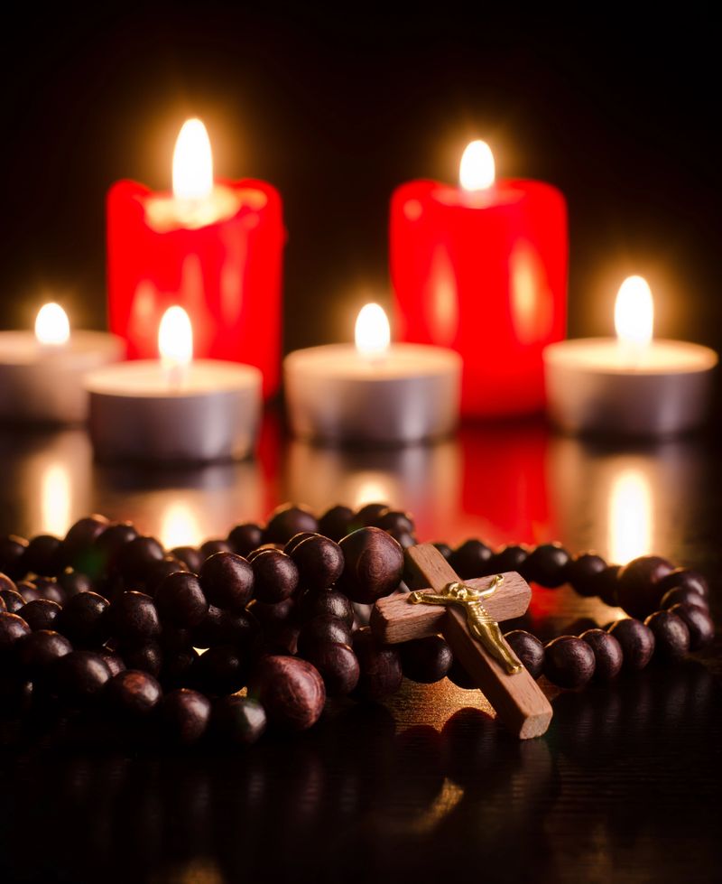 Closeup of wooden rosary on candlelight background