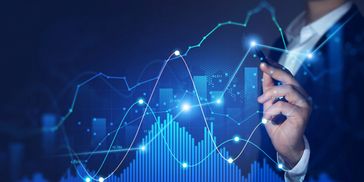 Businessman interacting with futuristic financial graphs and data.