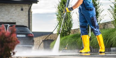 Power washing driveway with professional equipment and gear