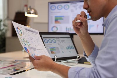 Person analyzing financial charts and graphs.