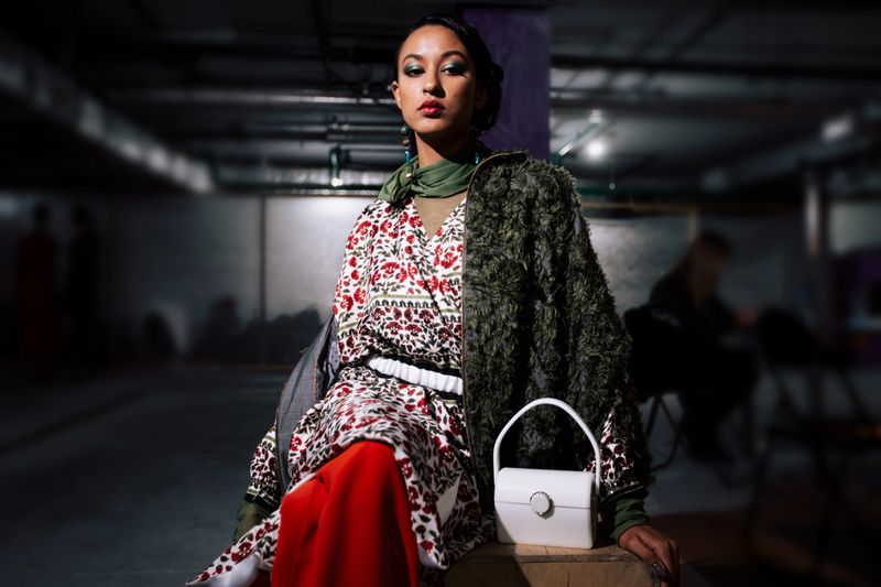 Female portrait of fashion woman at the backstage of fashion week show. Lifestyle photography, behind the scenes of new clothing collection. Girl wear by fashion designer. Haute Couture photo.