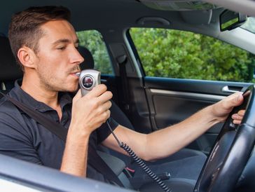 Ignition interlock breathalyzer device installed in vehicle