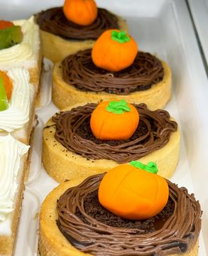Colorful fall-inspired cake with swirls and sprinkles.