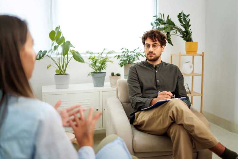 Psychologist talking with female patient during session at the office