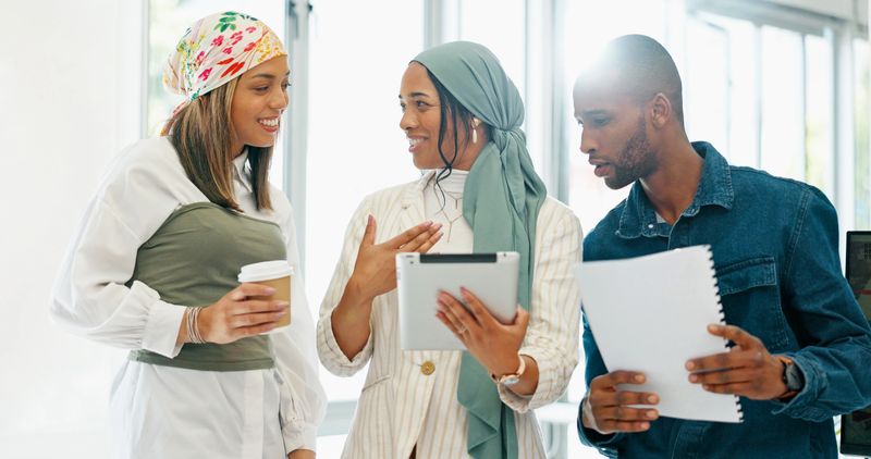 Business people, laughing or meeting with tablet, paper or documents in company joke, meme or funny comic website. Smile, happy or talking women and man on technology in diversity teamwork for brand