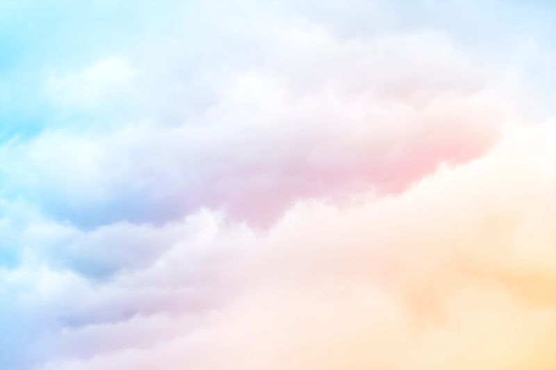 A soft cloud background with a pastel colored orange to blue gradient.