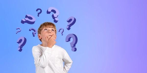 Boy pondering with question marks around.
