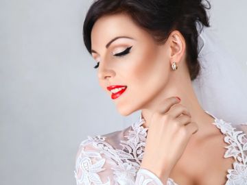 Elegant woman with red lipstick and lace dress.