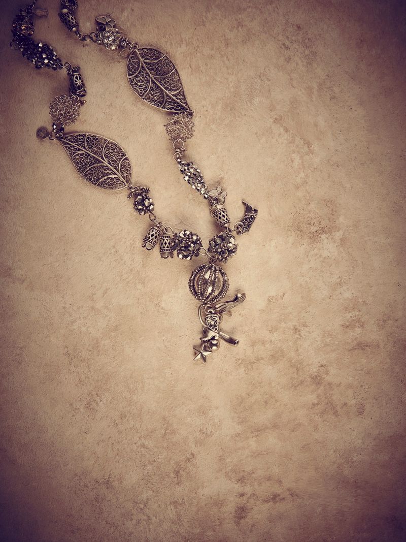 Elegant jewelry set ring, necklace and earrings with diamonds.Product still life concept. Modern and decorative textured background.