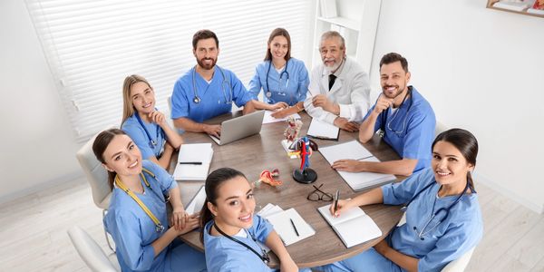 Medical team meeting around a table.