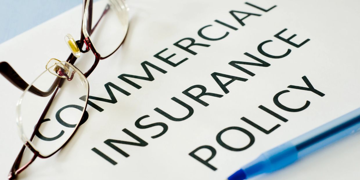 Commercial insurance policy document with glasses and pen on top.business liability insurance
commercial general liability
insurance coverage