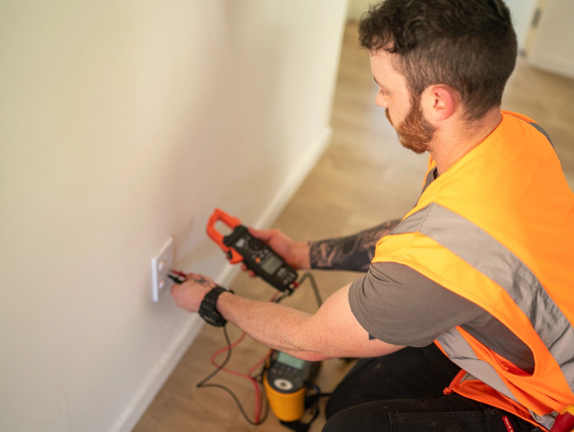man checking the voltage on  a 120 volt outlet