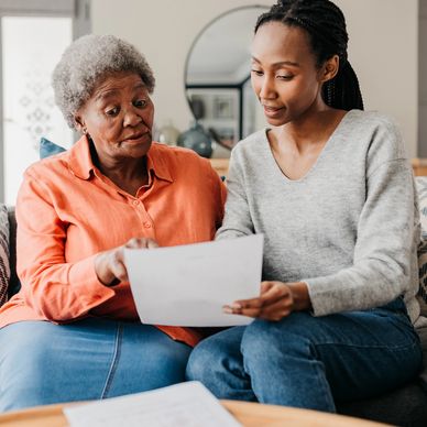 Two women reviewing a document together.