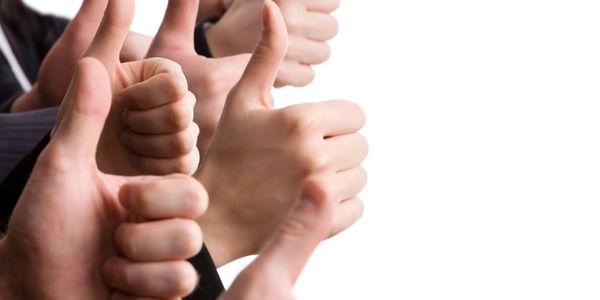 Multiple hands showing thumbs up against a white background.