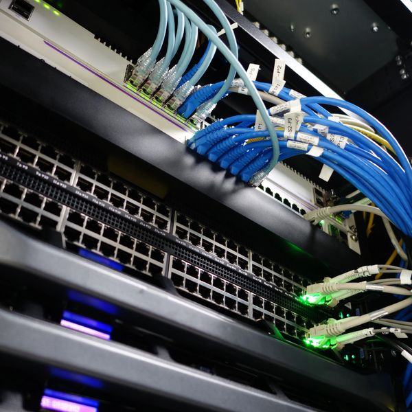 Network switches with connected Ethernet cables.