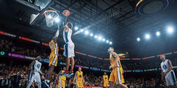 Basketball player dunking the ball during a game.