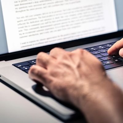 Image of hands typing on a lap top computer