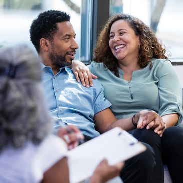 Couple smiling during therapy session.