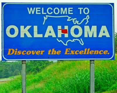 Welcome to Oklahoma road sign with slogan.