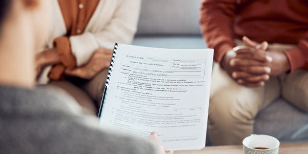 Two people attend a counseling session with a therapist.