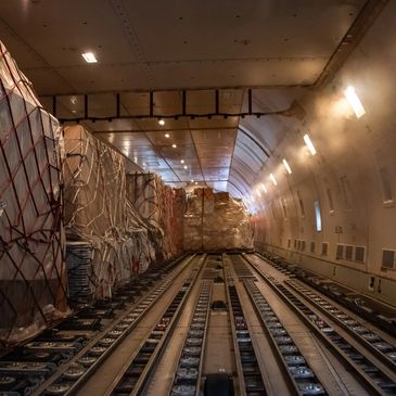Cargo pallets secured inside an aircraft's cargo hold.