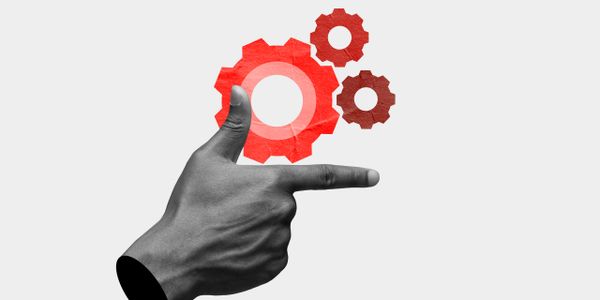 A hand pointing with red gears symbolizing mechanics or technology.